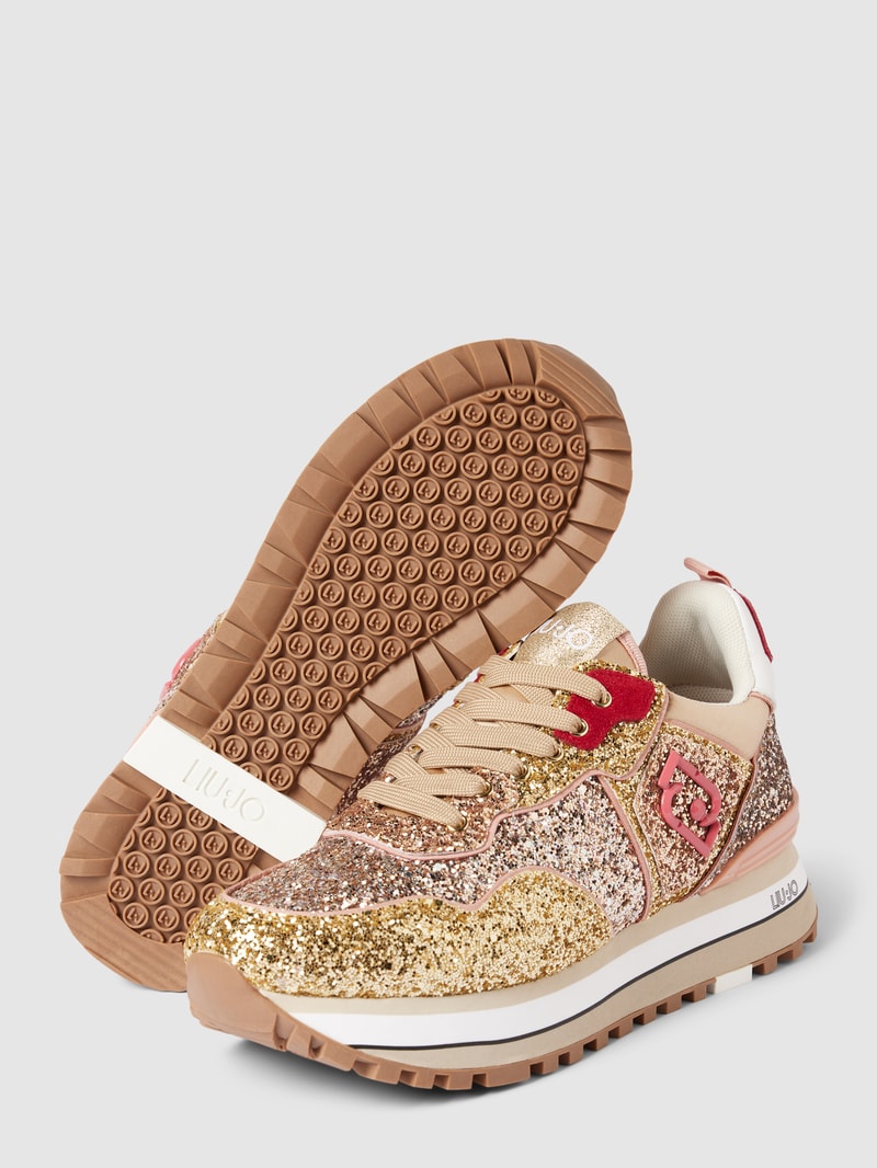 Sneaker mit Zierbesatz in gold