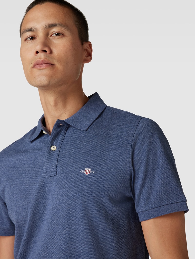 Poloshirt mit seitlichen Schlitzen Modell 'SHIELD' in jeans meliert
