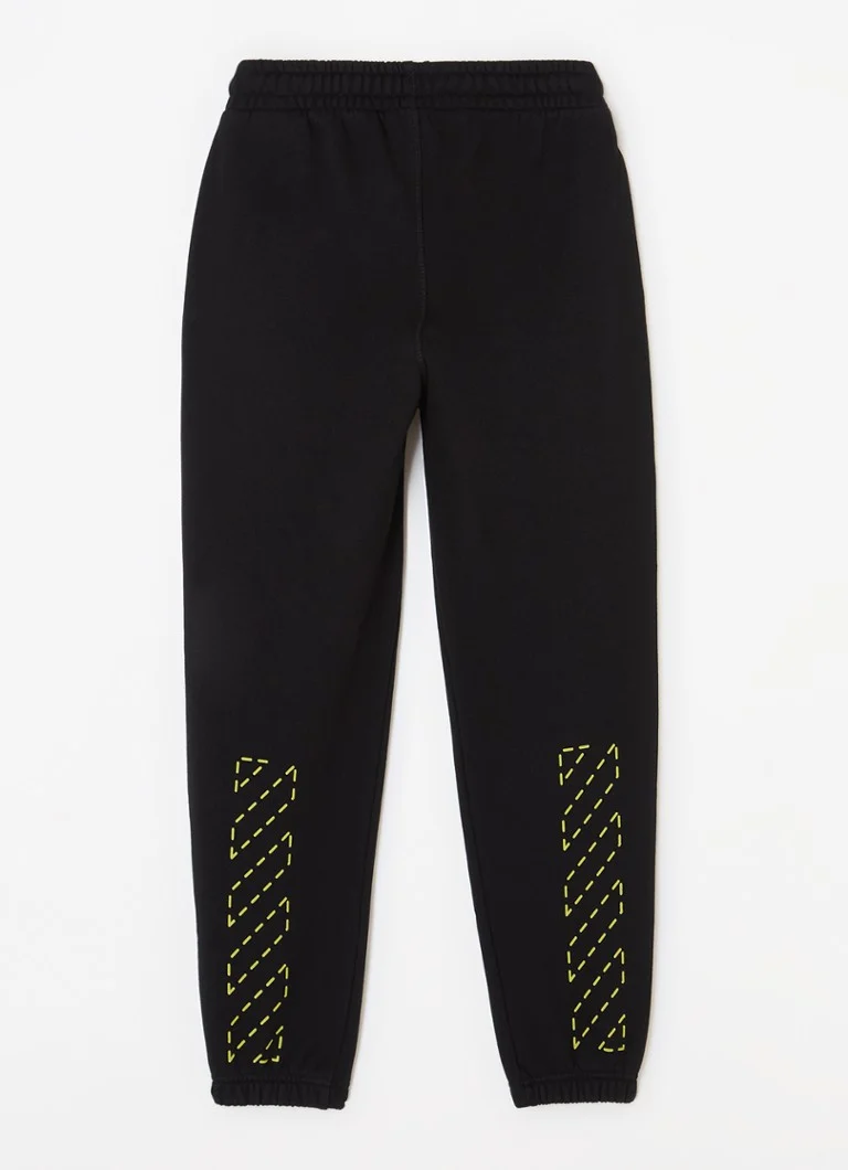 Pantaloni de trening mulați, de culoare alb-gălbui, cu logo imprimat.