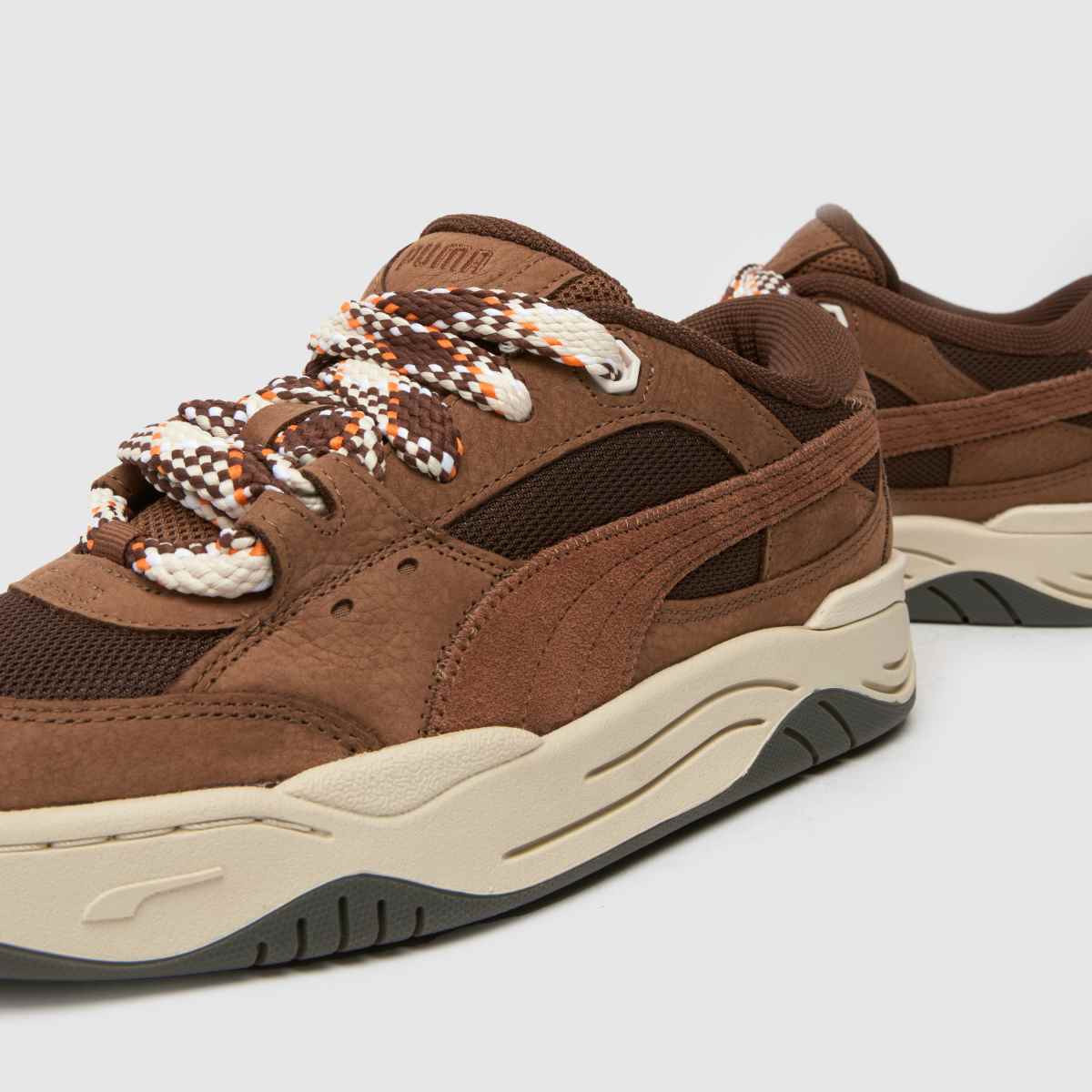 PUMA – 180 – Bruna, flerfärgade sneakers med spetsmotiv