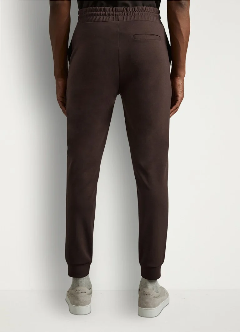 Pantaloni de trening conici Reiss Premier cu buzunare cusute.