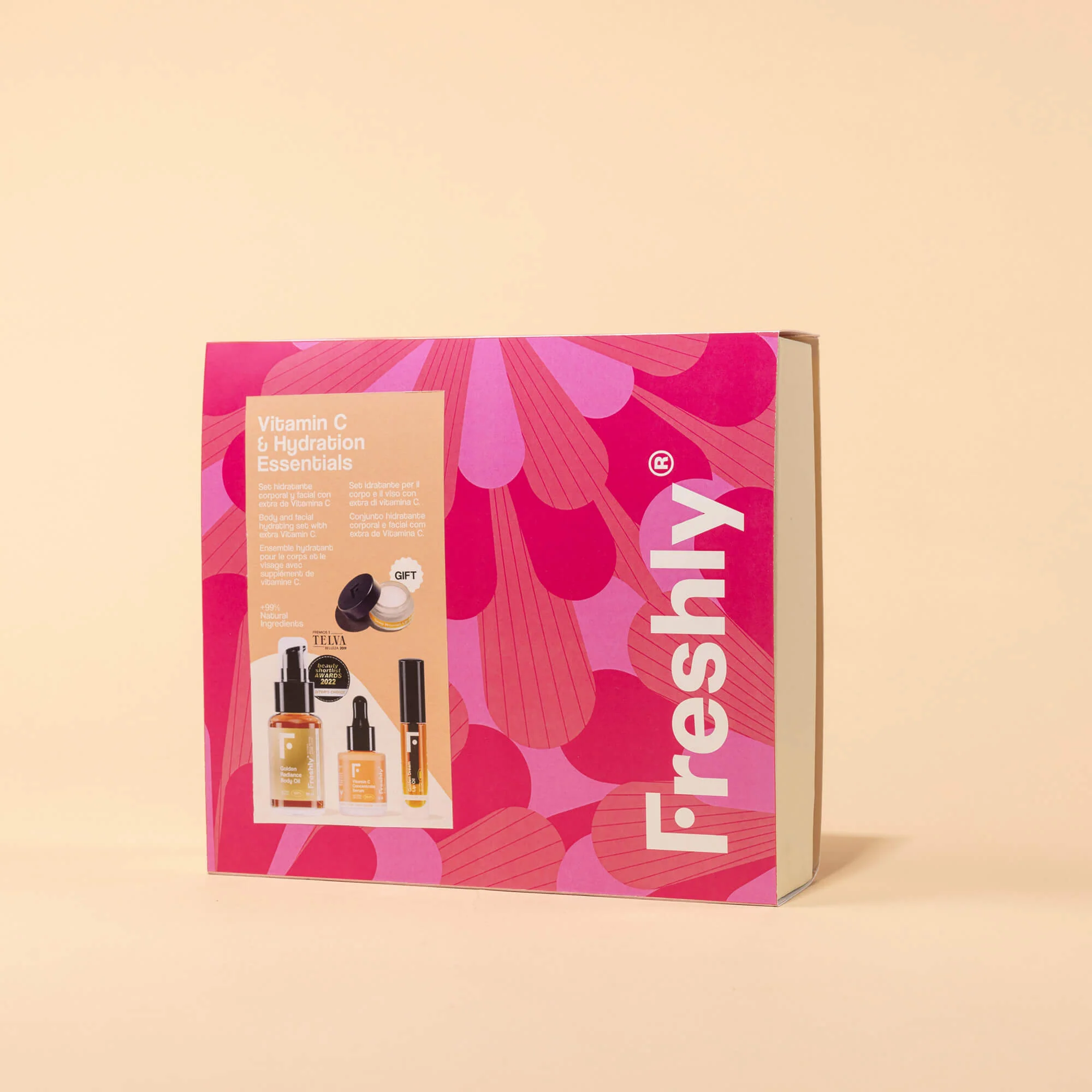 Set corporal esencial con vitamina C e hidratación: incluye productos para rostro y cuerpo, aceite reductor de estrías, sérum facial iluminador, brillo labial y bálsamo labial.