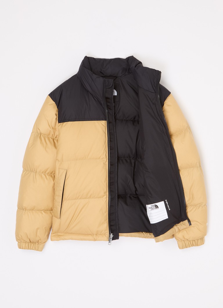 Jachetă de puf The North Face cu buzunare cu fermoar și logo brodat.