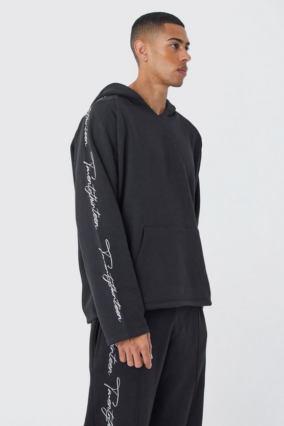 Oversize Trainingsanzug mit rohem Saum und Stickerei