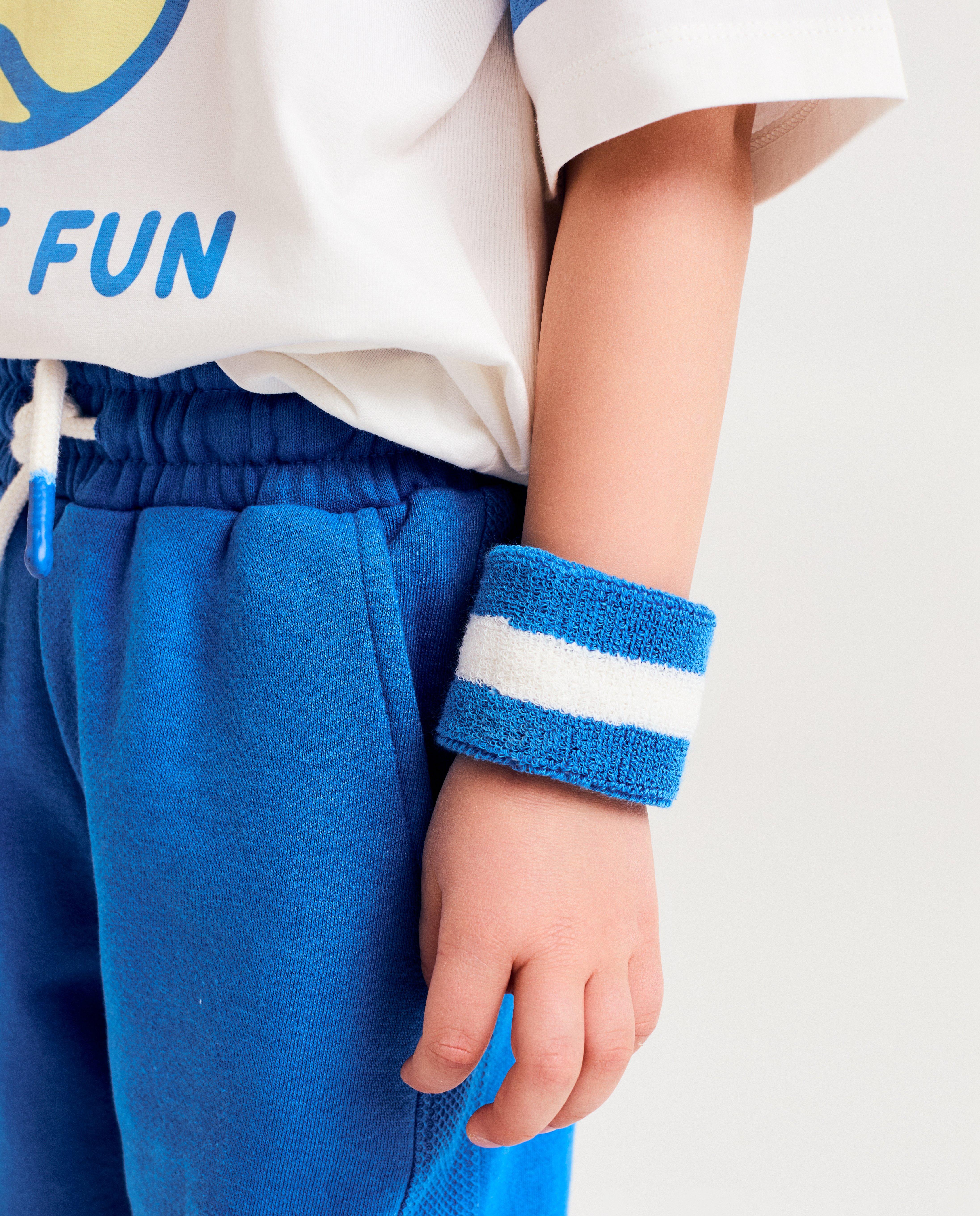 Set Kidz Nation: bandă pentru cap + brățări albastru strălucitor