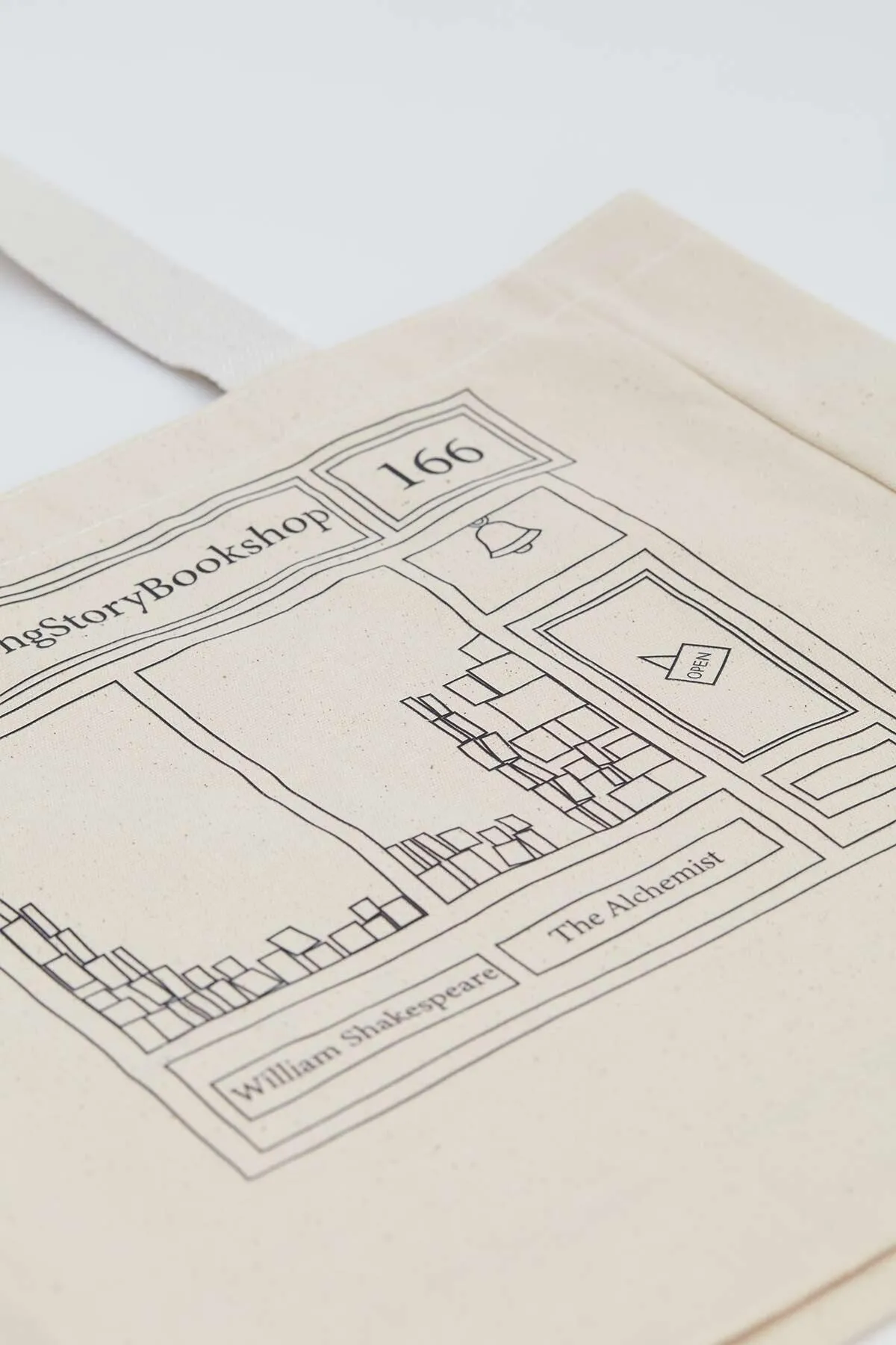 Manuka  Bedruckte Canvas-Einkaufstasche mit Seitenfalten Bookshop