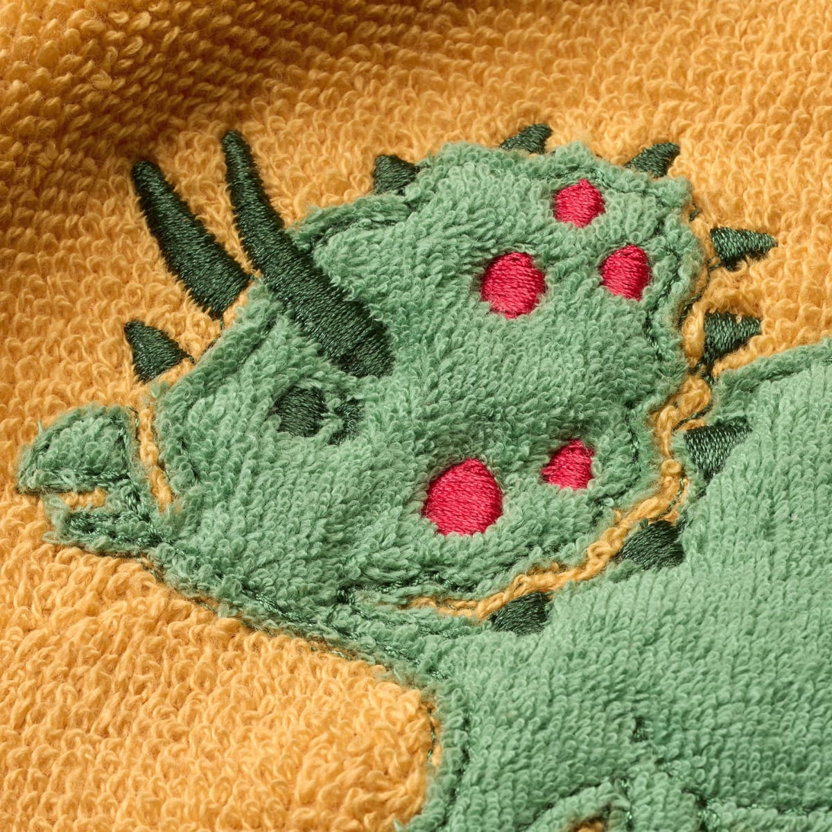 Ärmellätzchen mit Dino-Motiv, gelb, 1 St