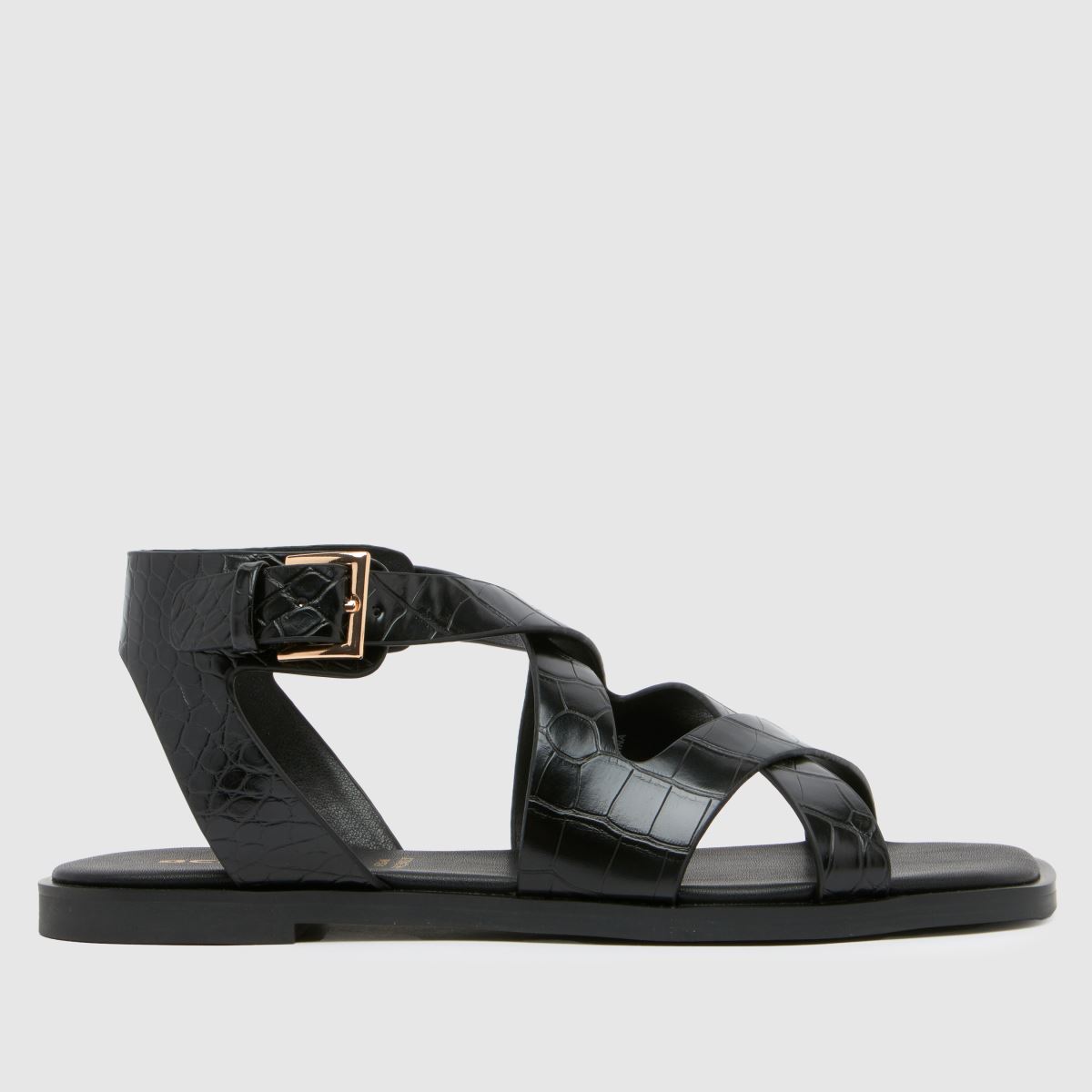 Schuh Tide – Svarta, platta sandaler med krokodilmönster