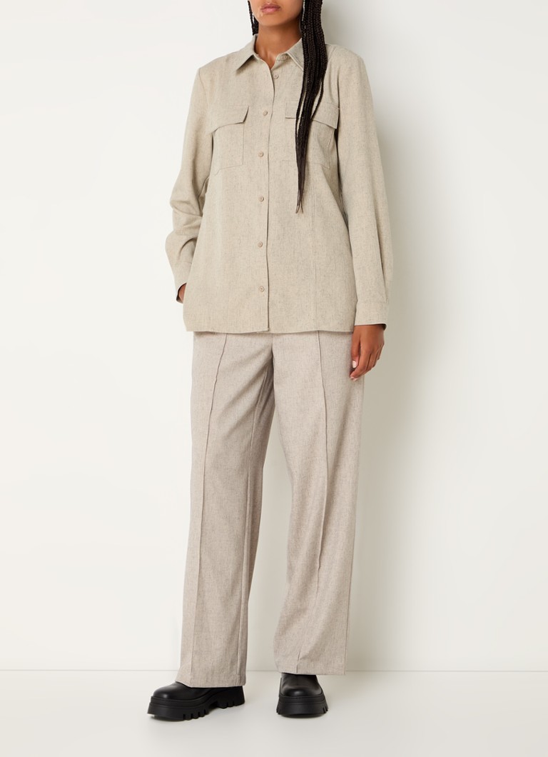 Pantaloni Kalem di Modström a vita media e taglio dritto, realizzati in misto lino con tasche laterali.