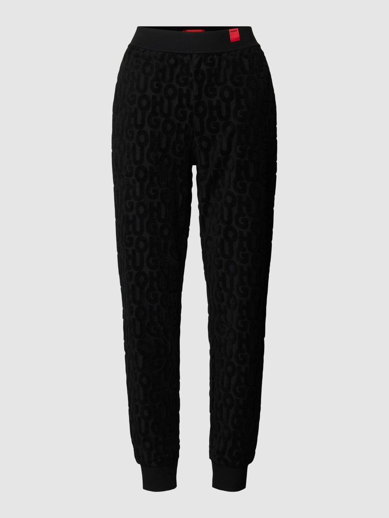 Jogpants mit Allover-Label-Muster aus Frottee Modell 'TERRY ME' in schwarz