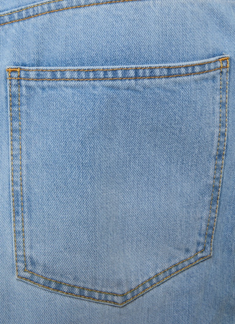 Alaïa light wash denim jumpsuit