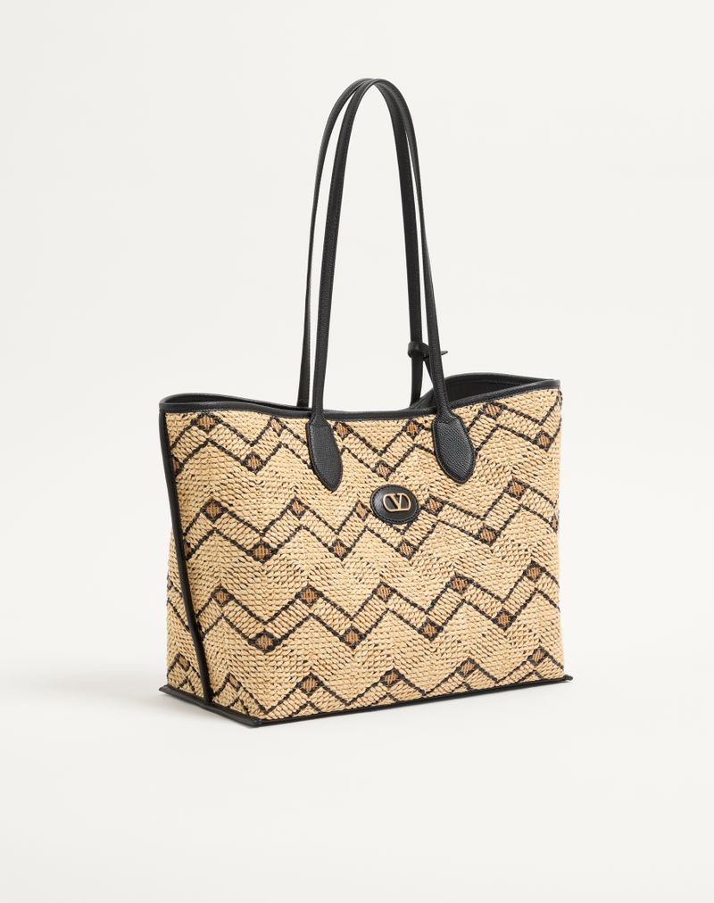 Bolsa de compras média Valentino Garavani em ráfia com estampa geométrica.