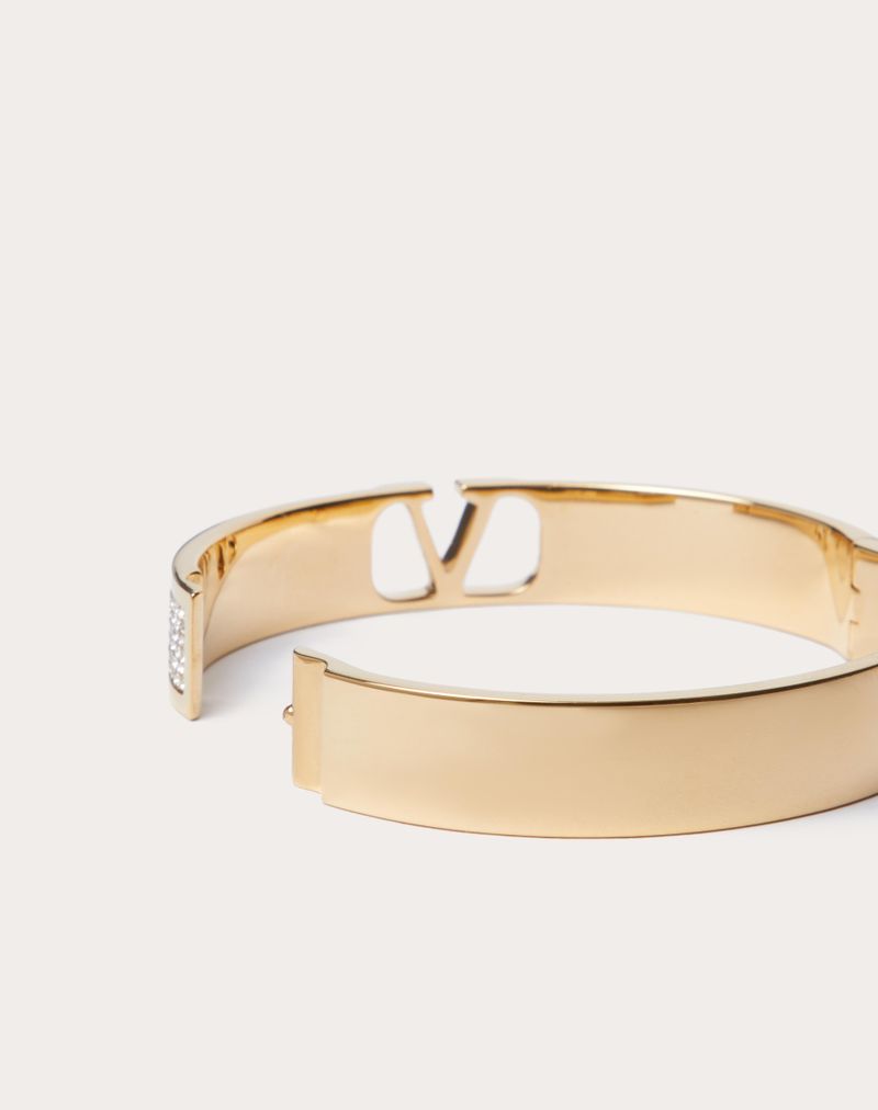 PULSEIRA DE ASSINATURA VLOGO EM METAL E CRISTAIS SWAROVSKI®