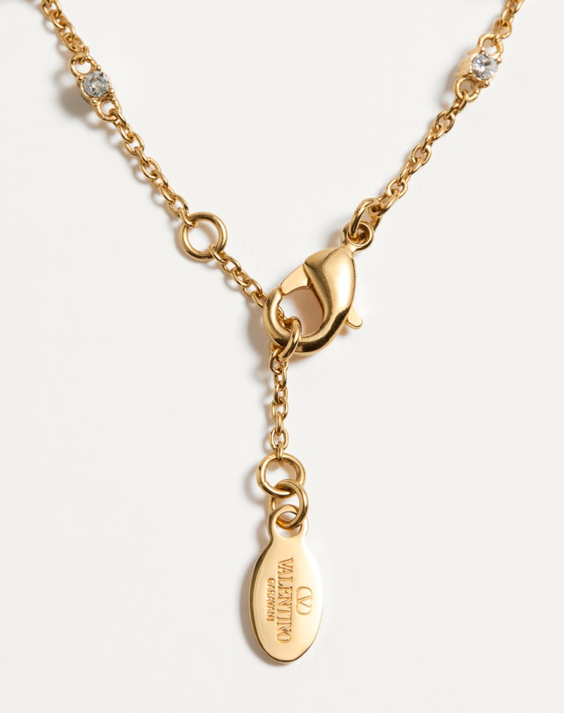 Pulseira com o logotipo V em metal, cristais Swarovski® e pérolas.