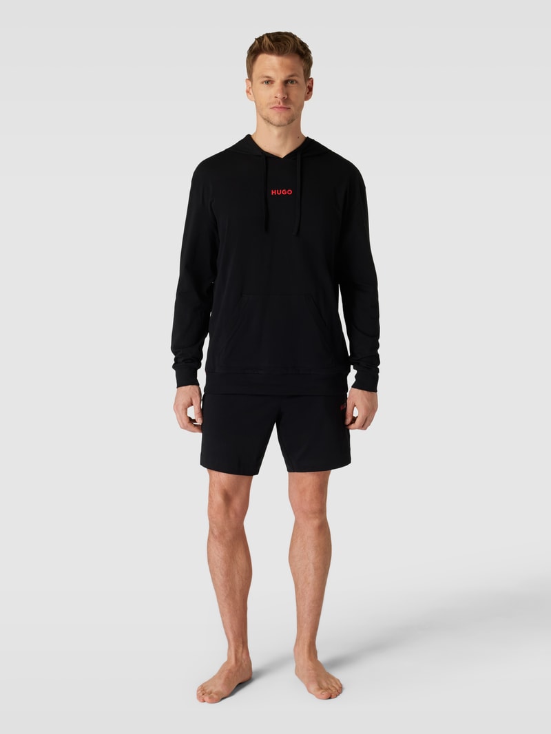 Hoodie in unifarbenem Design mit Känguru-Tasche in schwarz