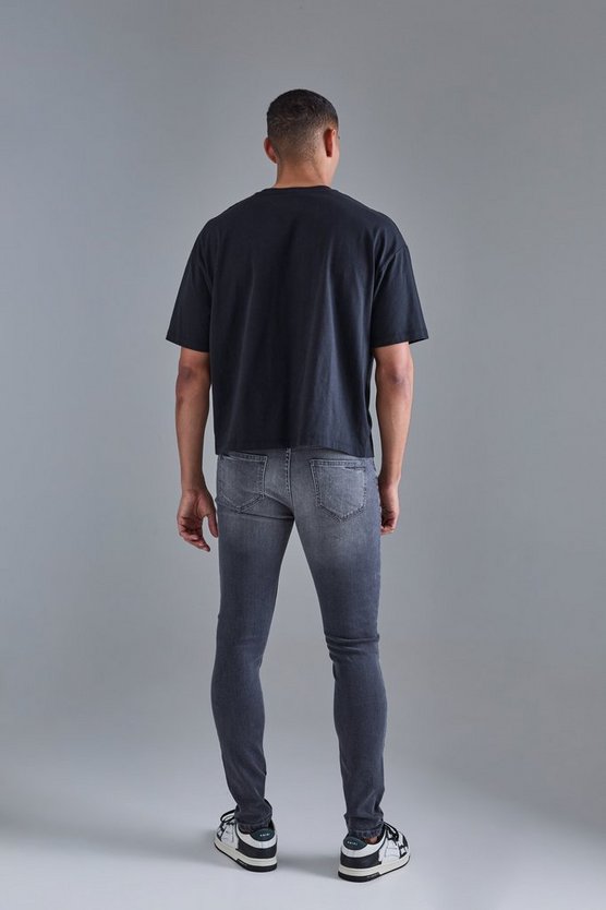 Schwarze Skinny Stretch PU Bikerjeans mit Rissen