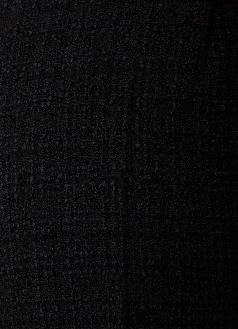 Calças Sandro de cintura alta, corte amplo e tecido bouclé com bolsos embutidos.