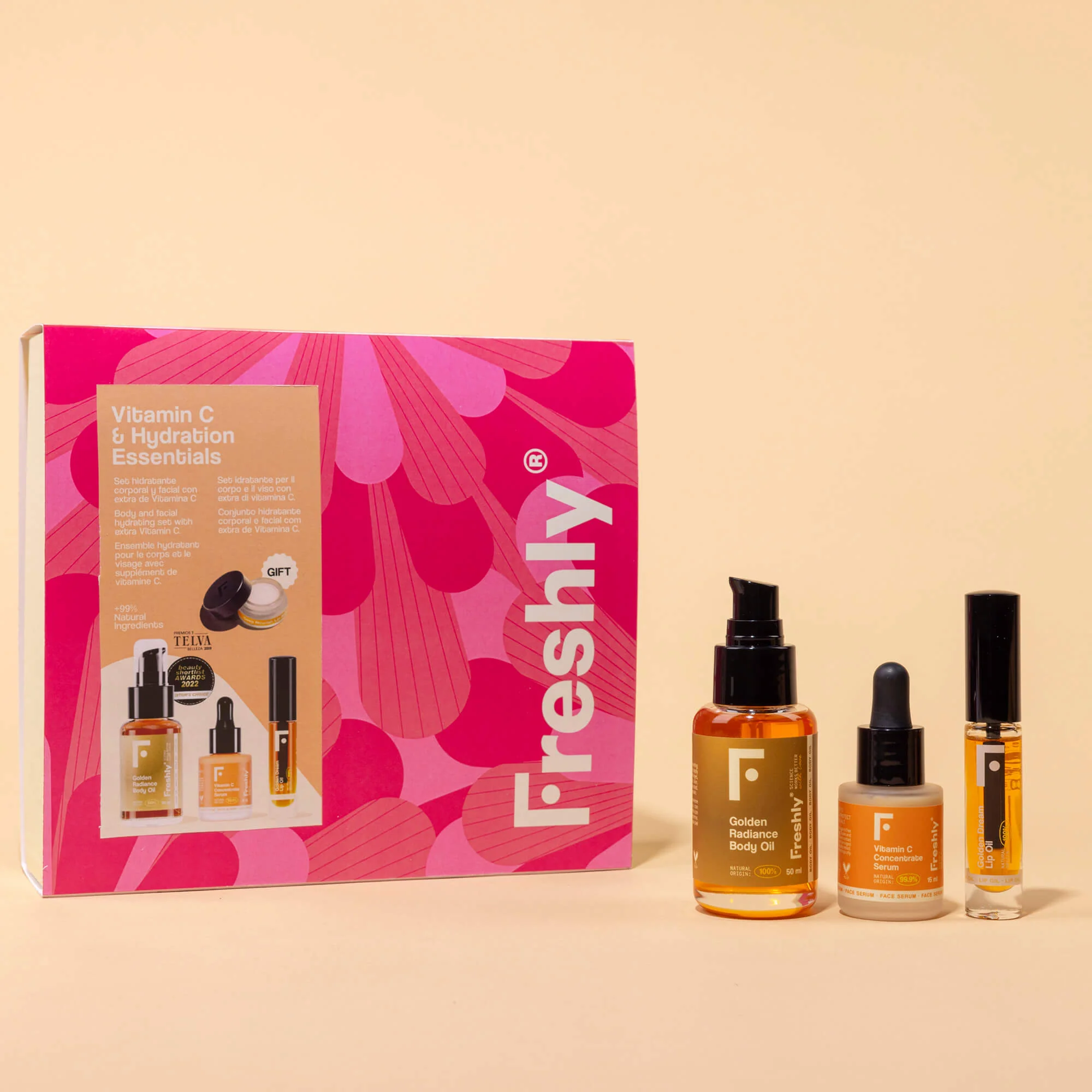 Set corporal esencial con vitamina C e hidratación: incluye productos para rostro y cuerpo, aceite reductor de estrías, sérum facial iluminador, brillo labial y bálsamo labial.
