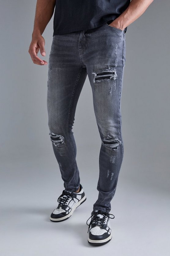 Schwarze Skinny Stretch PU Bikerjeans mit Rissen