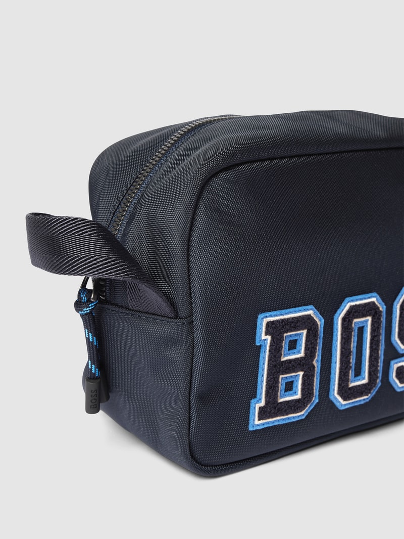 Kulturtasche mit Label-Applikation Modell 'Catch 2.0' in marineblau