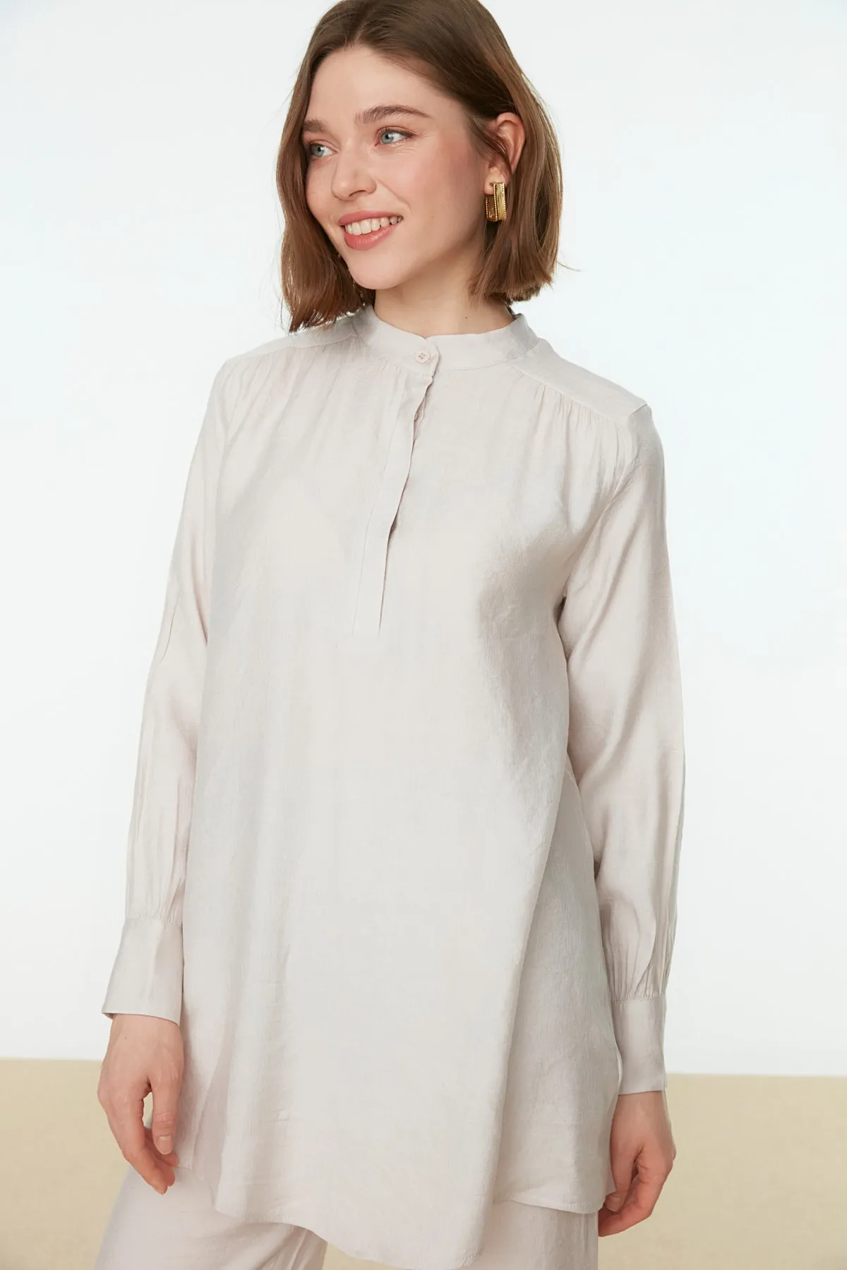 Trendyol Modest  Cremefarbenes, halb verdecktes Tunika-Hosen-Set mit Schulterdetail und Knopfleiste TCTSS22US0098