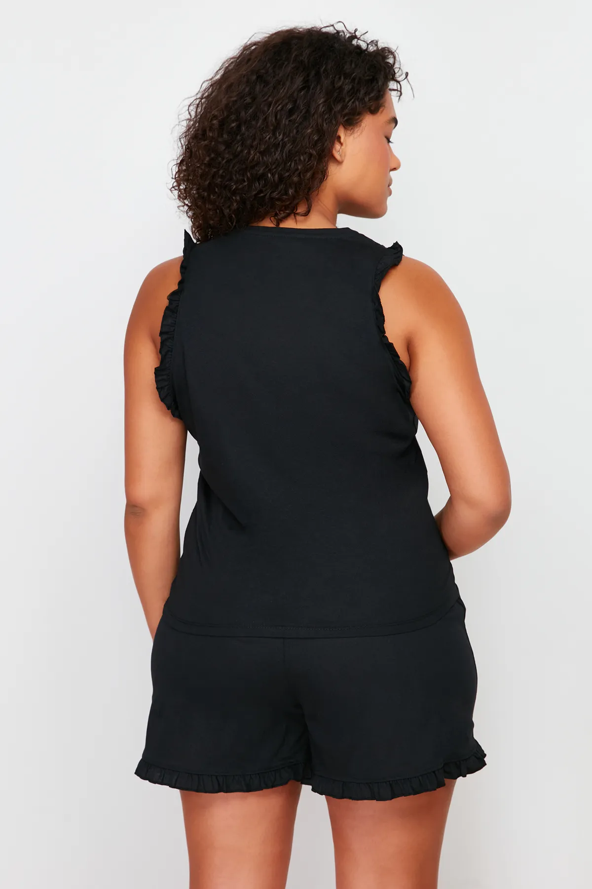 Trendyol Curve  Schwarzes Pyjama-Set aus Strick mit Sportlershorts und Rüschendetail TBBSS24AI00017