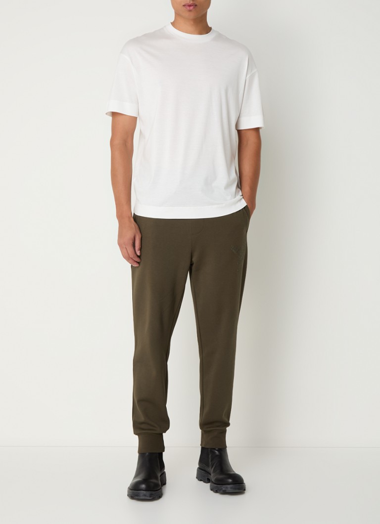 Pantaloni de trening slim fit de la Armani Exchange, cu broderie și buzunare laterale.