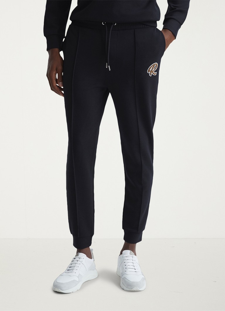 Pantaloni de trening conici Reiss Premier cu buzunare laterale.