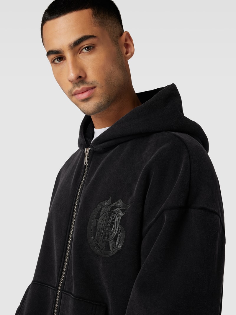 Sweatjacke mit überschnittenen Schultern in schwarz