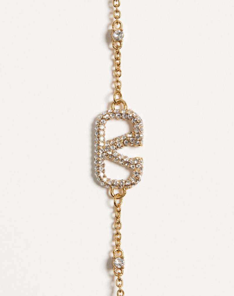 Pulseira com o logotipo V em metal, cristais Swarovski® e pérolas.