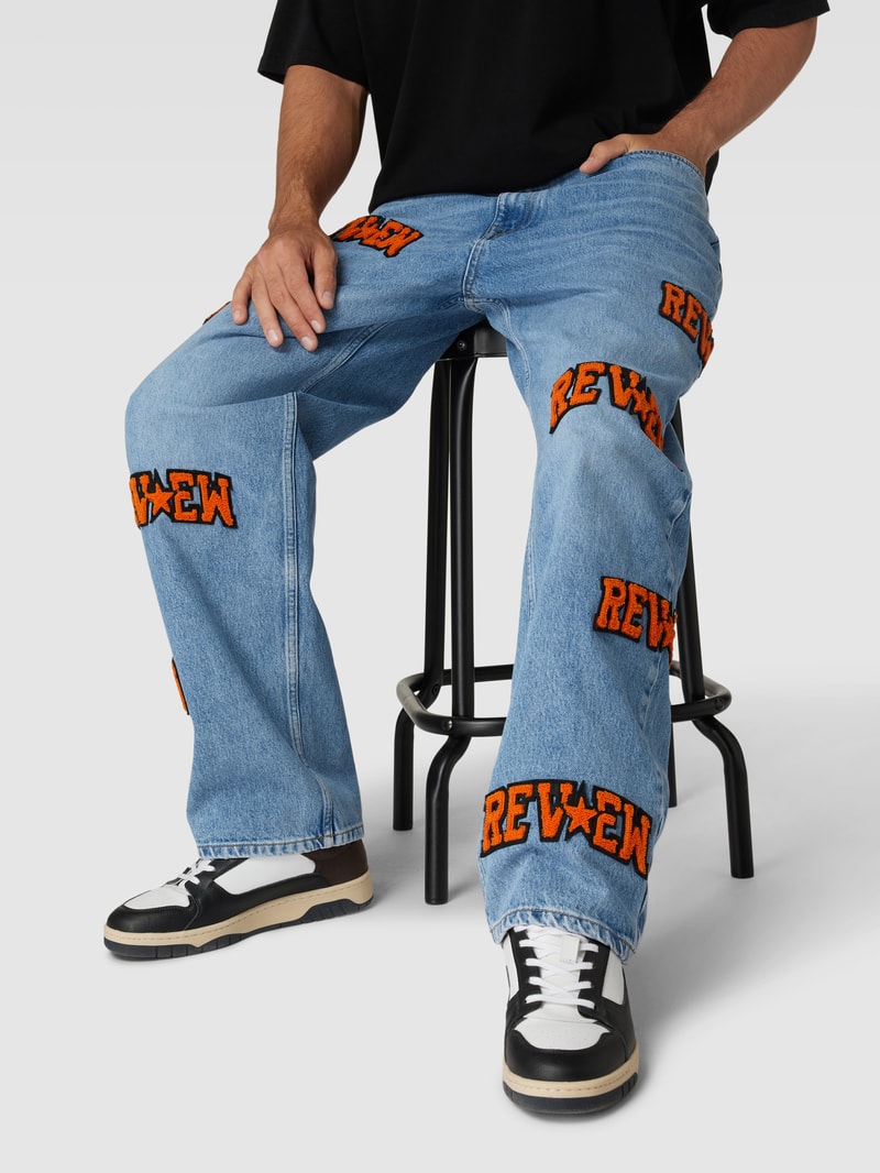Baggy Jeans mit Allover-Label-Patches in blau