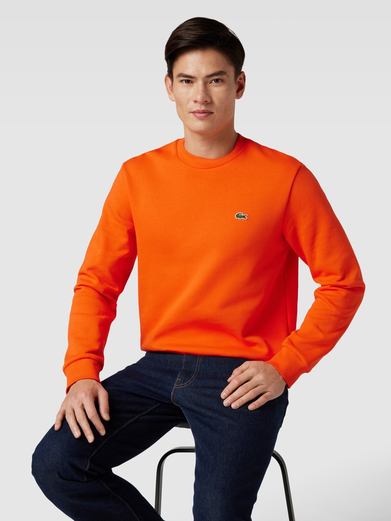 Sweatshirt in unifarbenem Design mit Label-Stitching in orange