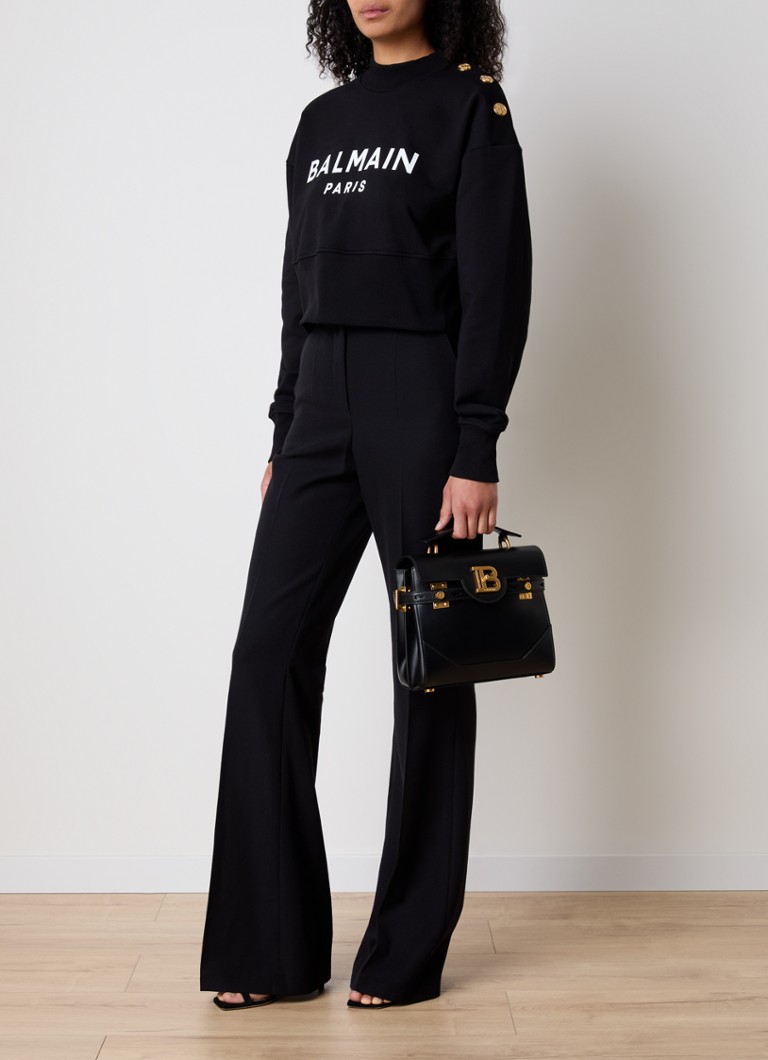 Krótki sweter Balmain z ozdobnymi guzikami i logo.