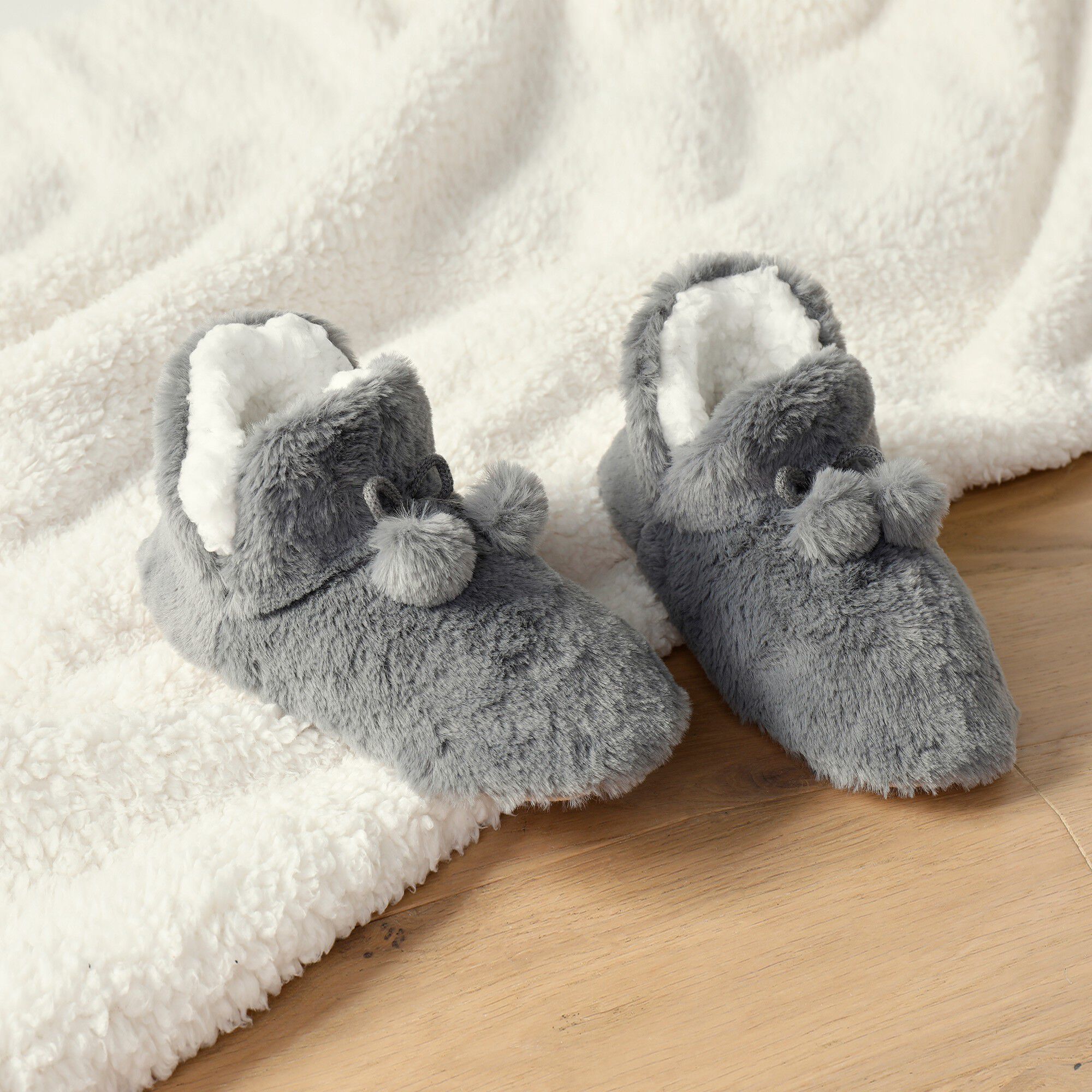 Chaussons forme botillon avec pompons effet fausse fourrure