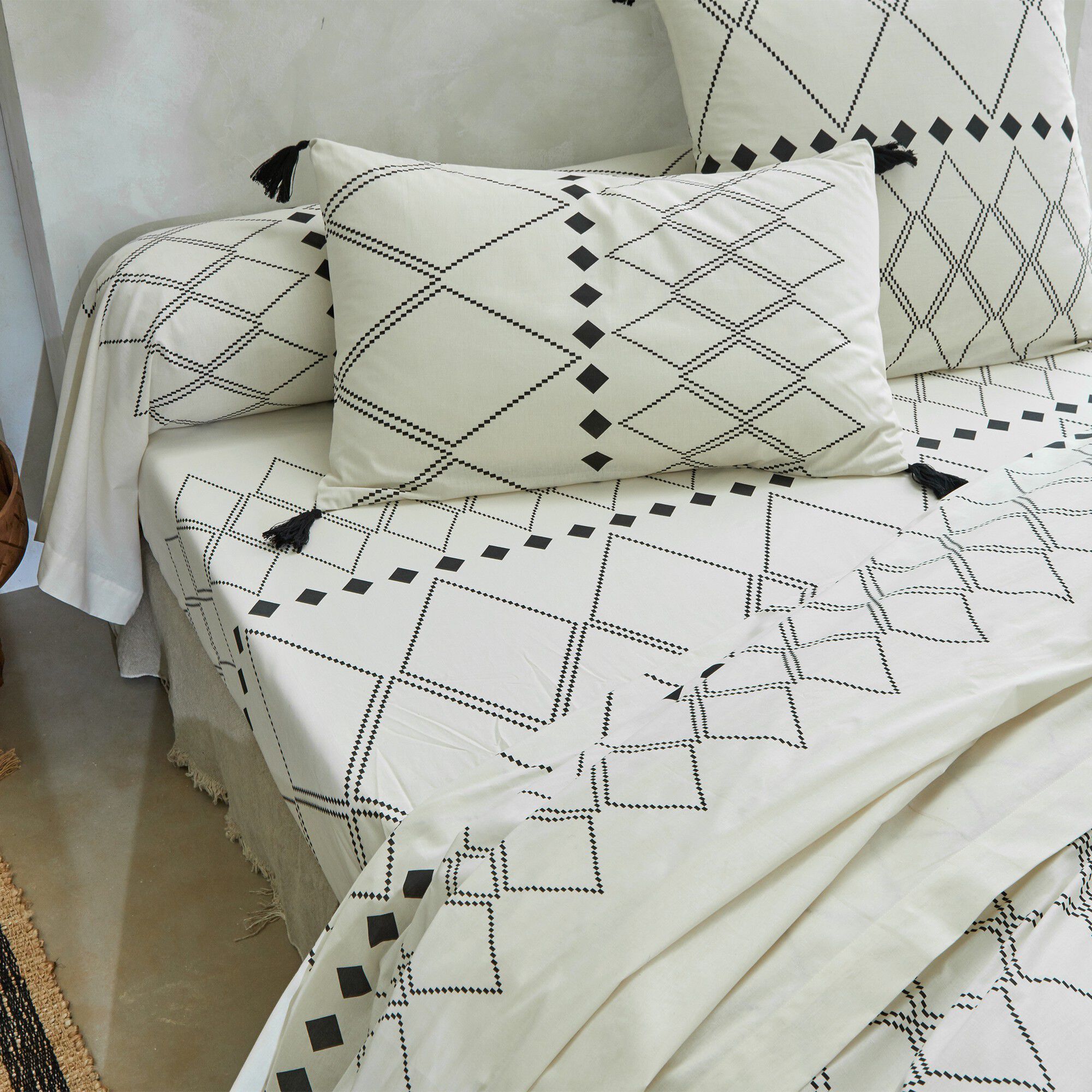Linge de lit Massaï coton à motifs graphiques et finitions pompons