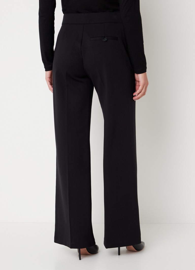 Calças SPANX de cintura alta e corte flare, confeccionadas em malha com costura divisória.