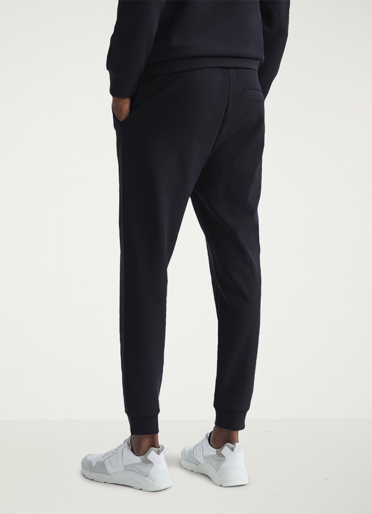 Pantaloni de trening conici Reiss Premier cu buzunare laterale.