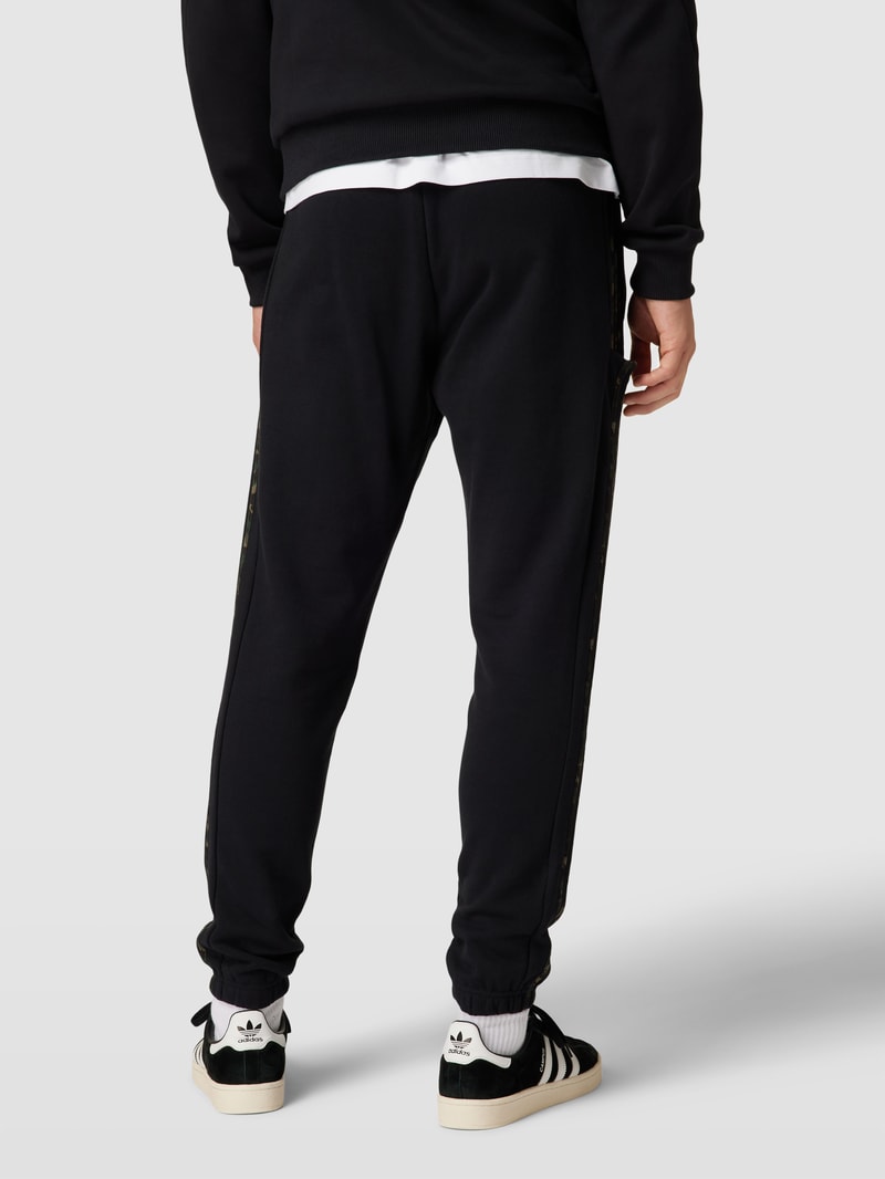 Jogpants mit elastischem Bund und Tunnelzug in schwarz