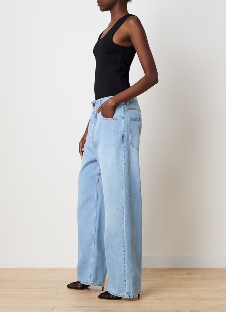 Alaïa light wash denim jumpsuit