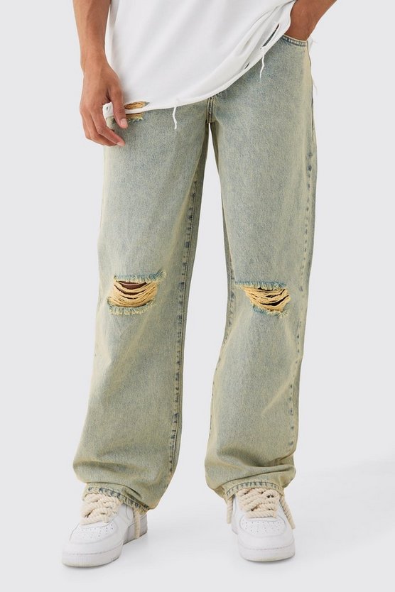 Lockere grüne Jeans mit Riss am Knie