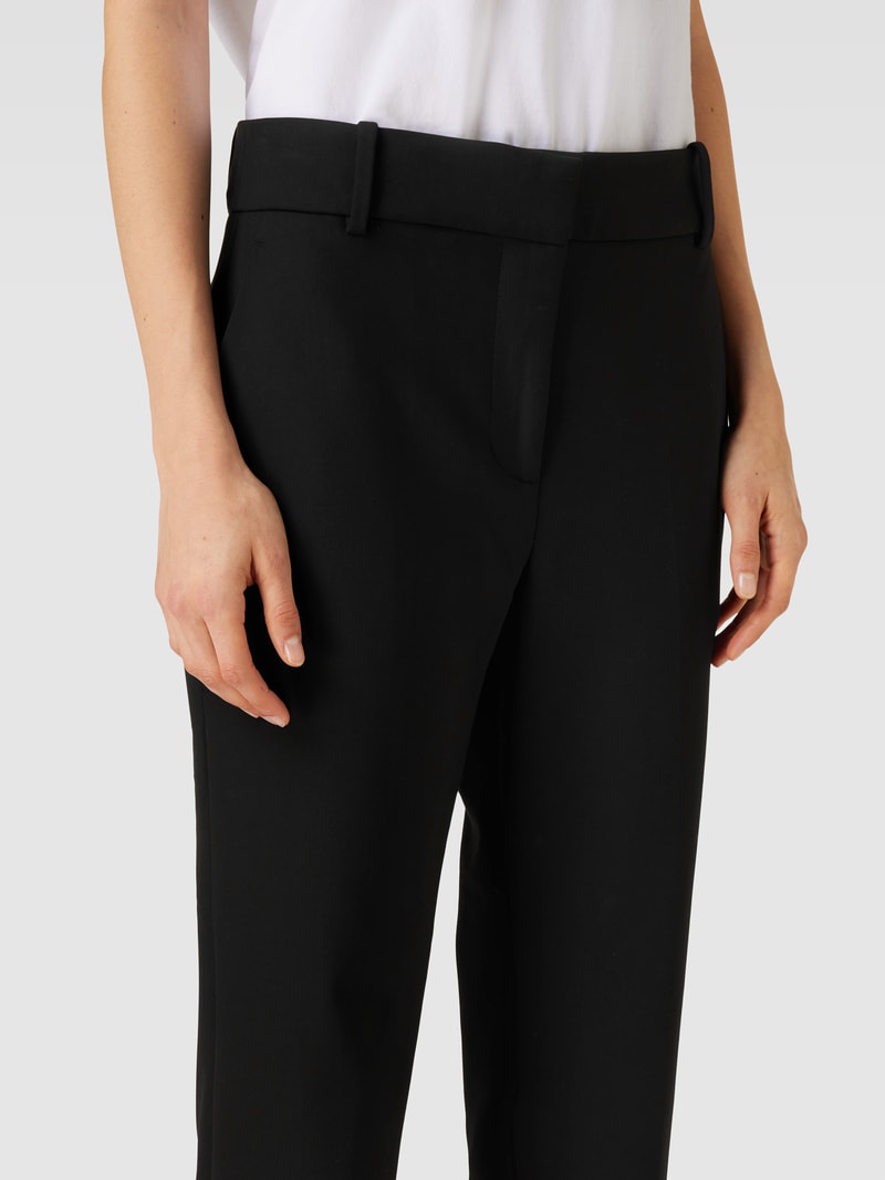 Stoffhose in unifarbenem Design mit Eingrifftaschen in schwarz