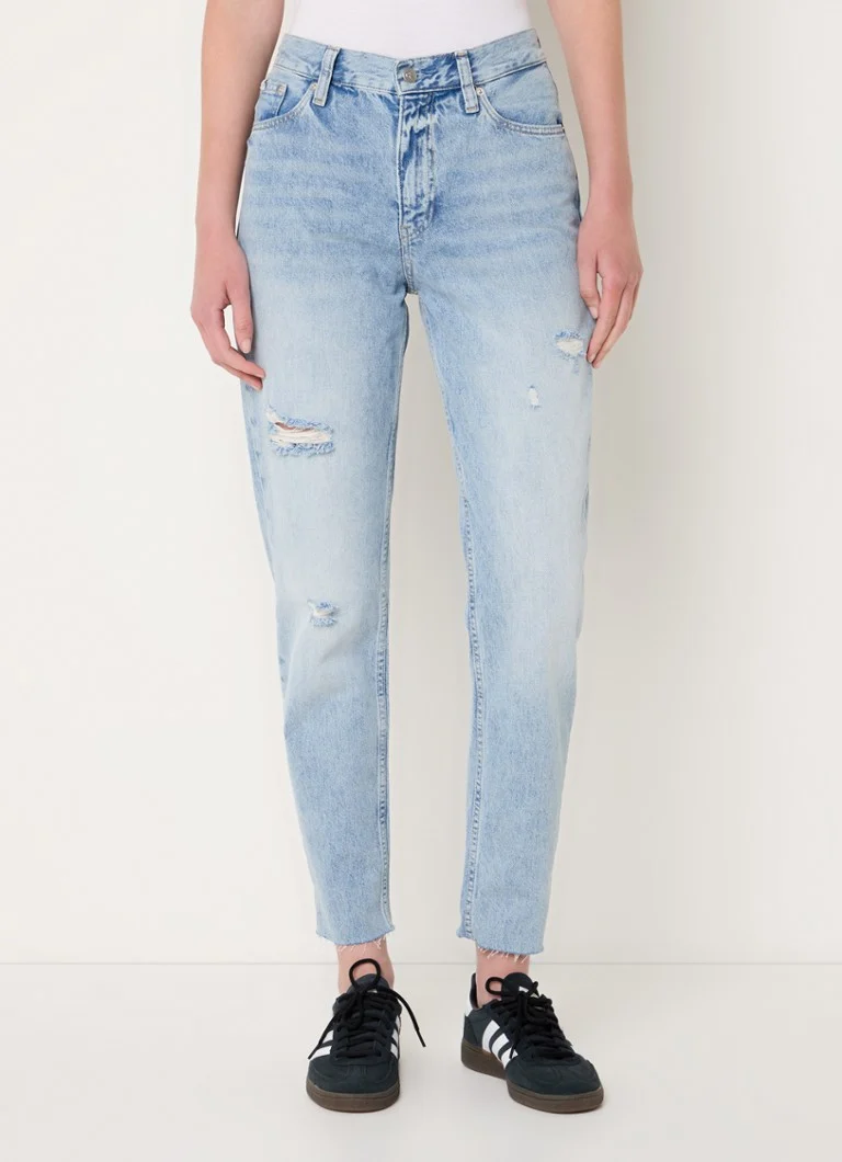 Calvin Klein high-waist mom jeans with a light wash and destroyed finish
