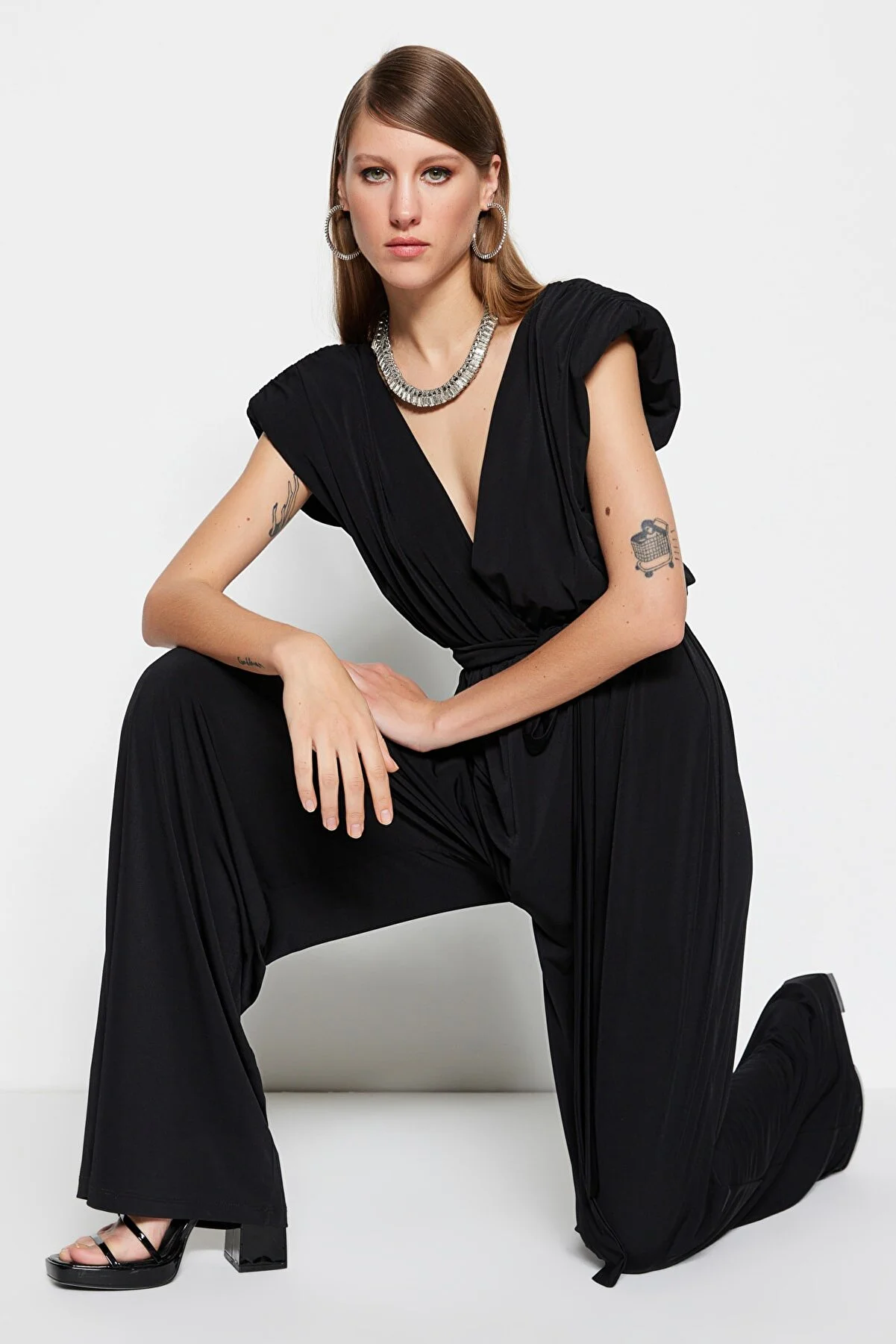Trendyol Collection  Schwarzer Strick-Jumpsuit mit V-Ausschnitt und Gürtel TPRSS23TU00029