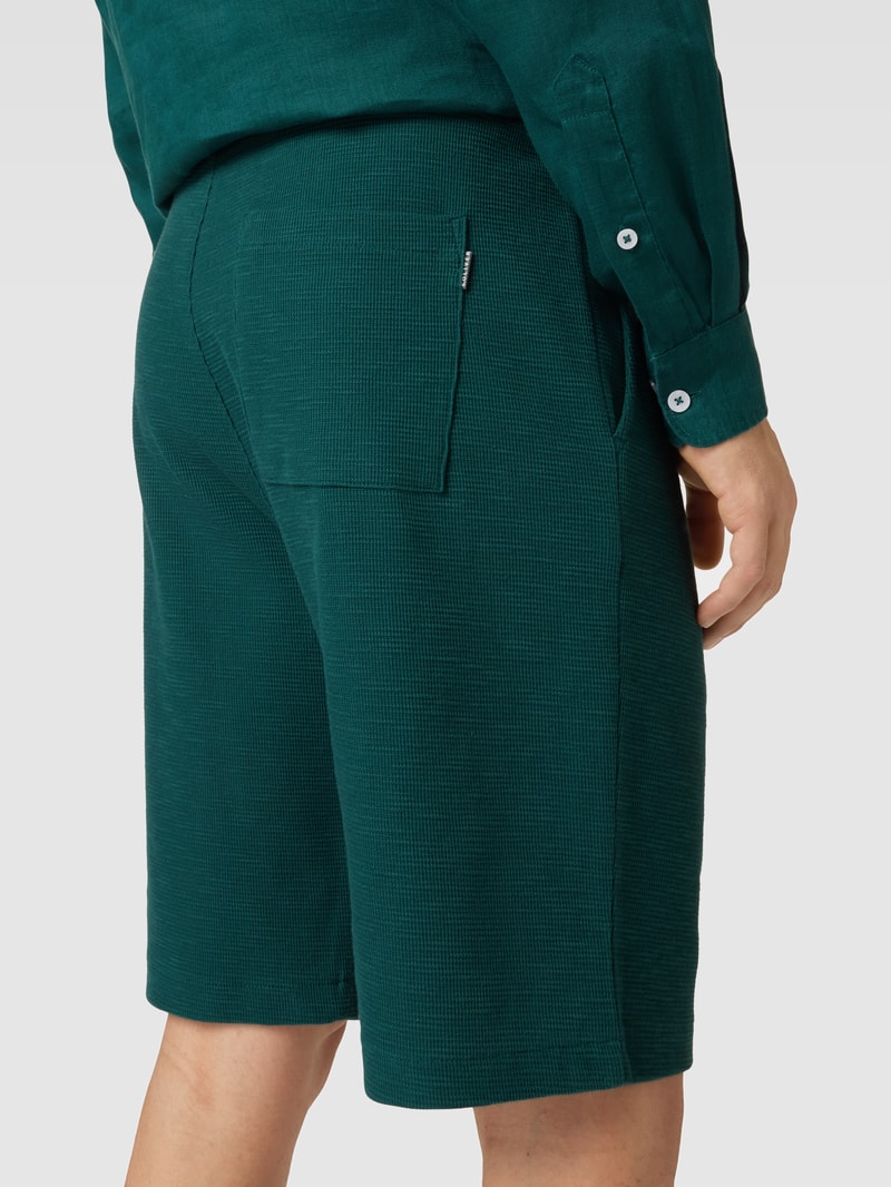 Shorts in unifarbenem Design Modell 'Waffle' in petrol