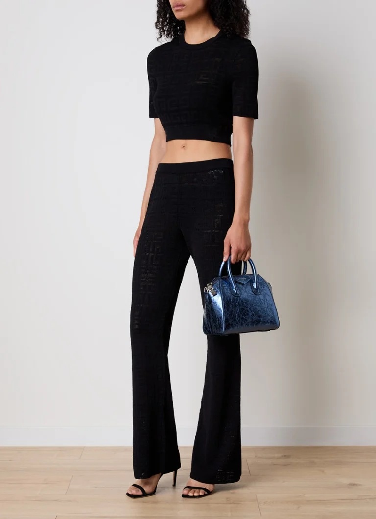Pantaloni Givenchy a vita media e gamba svasata in maglia fine con motivo traforato.