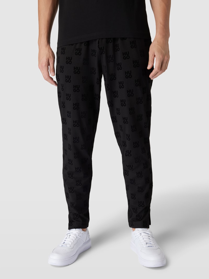 Sweatpants mit Allover-Logo-Muster Modell 'Flock' in schwarz