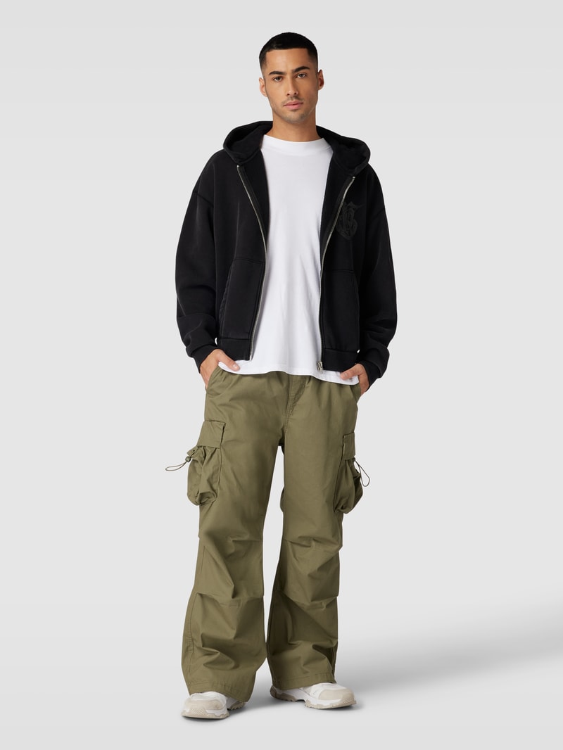 Sweatjacke mit überschnittenen Schultern in schwarz