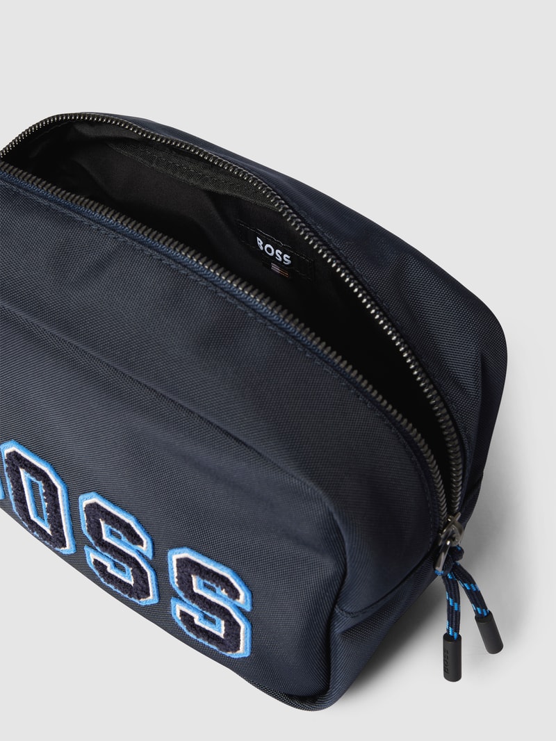 Kulturtasche mit Label-Applikation Modell 'Catch 2.0' in marineblau