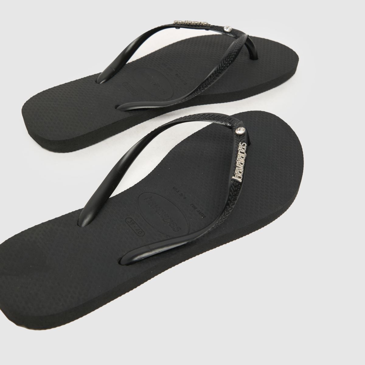 Havaianas – Svarta smala sandaler med metalllogotyp och kristaller