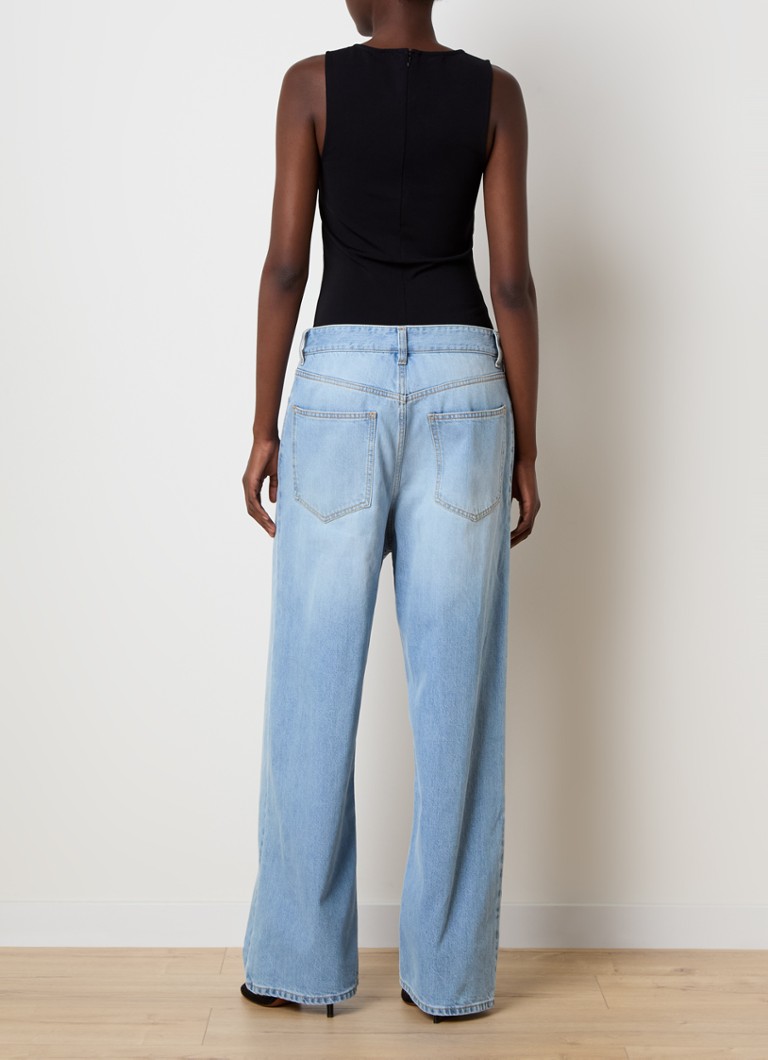 Alaïa light wash denim jumpsuit